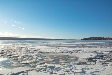 White broken ice on a frozen lake