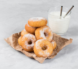 Cottage cheese donuts with milk on a light background