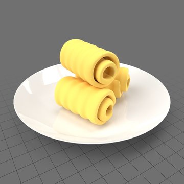 Rolls of butter on plate