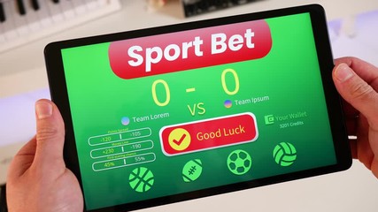 Sport bet application on a tablet device. Player placing a bet on his favorite team.