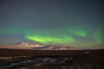 Fototapeta na wymiar Northern lights at the night sky of Iceland