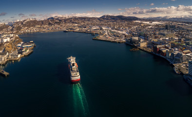 The coastal express ship Hurtigruten MS Polarlys arrives at Bodø harbor just after noon.