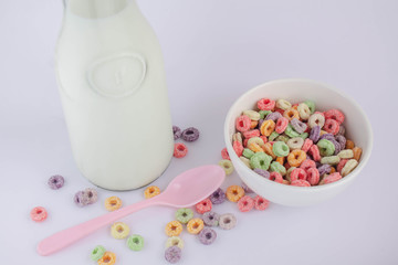 milk and fruit cereal in bank cup with milk jug