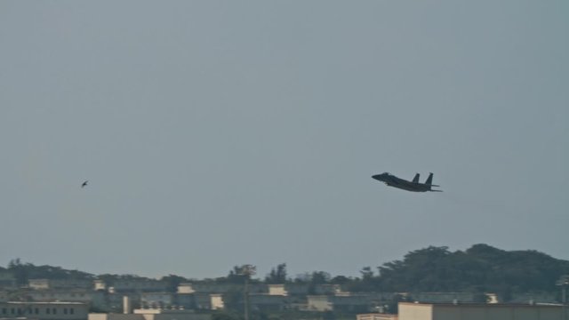 Kadena AB Okinawa Japan Feb 21 2020 Military aircraft taking off and on runway fighter jet, refueler, air tanker, A10, F15,C130 USAF