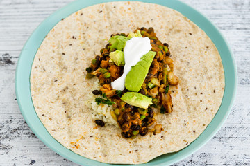 healthy blant-based recipes, beans rice and avocado open wrap with vegan aioli