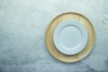 Top view, Closed up empty blank dishware on wooden tray and place on grey granite table.