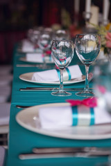 Banquet of the wedding party dinner. Luxury decor decorated tables with flowers, tableware and in turquoise pink colors.