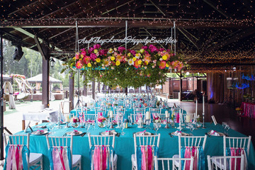 Banquet of the wedding party dinner. Luxury decor decorated tables with flowers, tableware and in turquoise pink colors. Silk ribbons. Romantic inscription: And they lived happily ever after.