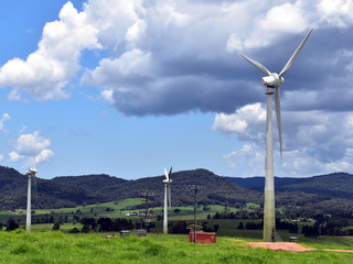 A section of a wind farm shows three wind turbines in the Atherton Tablelands in Tropical North...