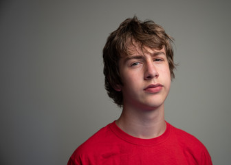 Portrait of an annoyed teenage boy. Negative attitude concept.