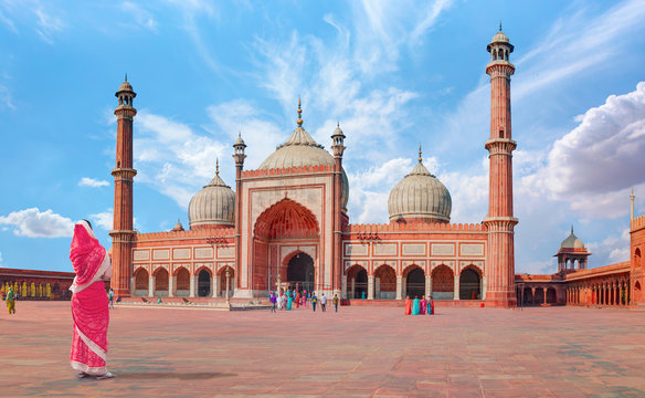 Young woman in traditional red clothes - Jama Masjid, Old town of Delhi, India 