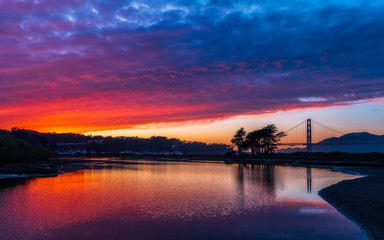 San Francisco's Golden Gate Bridge with a Fiery, Rainbow Color Sunset with Reflection