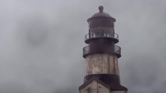 Fog surrounding an old lighthouse on the coast