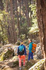 Obraz premium Two girls walk in the woods.