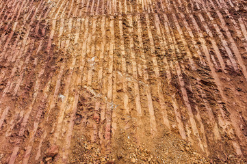 Mountain cutting by backhoe for road constructions in Laos.