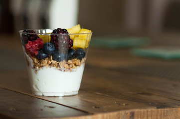 Yogurt parfait with fruits on table - obrazy, fototapety, plakaty