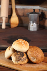 Assortment of bread rolls at rural kitchen background