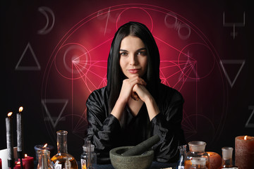 Portrait of female alchemist on dark background