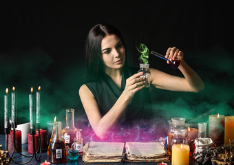Female alchemist making potion on dark background