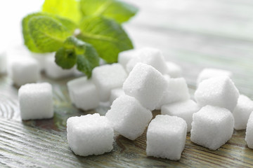 Cubes of sweet sugar on wooden background