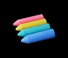 Colored chalk on a dark school board. The concept of children's creativity games, back to school. Blackboard with multicolored strokes from the chalk. Background texture with place for text, flat lay.