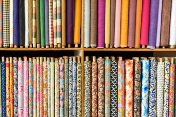 Traditional colorful Indian clothes stacked in a textile showroom