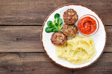 Juicy delicious turkey meat cutlets served with mashed potato and sauce.