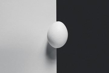 Abstract image. A single egg on the splitted background. Possible concepts of loneliness, Divorce, separation,