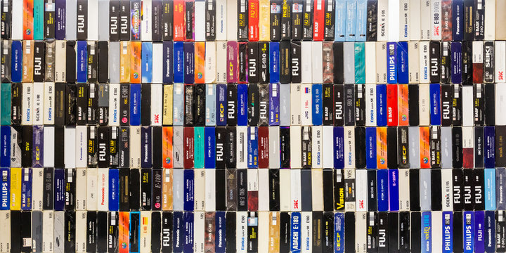 Saratov / Russia - February 15, 2020: A stack of videotapes in VHS format. Colorful boxes of cassettes.