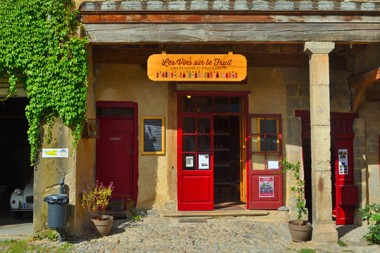 Colourful little wine shop front on the old square at Lagrasse Languedoc France. 