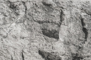 Texture of a stone Granite slab. Rough gray granite. Textured stone background. Stone slab of the ruins of an ancient city.