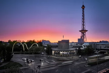 Tuinposter Blue hour with a purple orange sky from a bird's eye view with a view of the radio tower in Berlin © Gregor