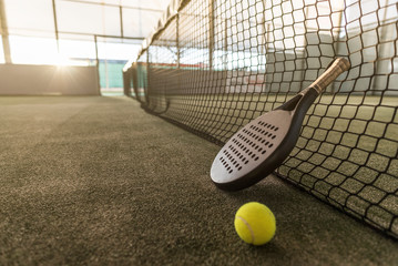 Paddle tennis image of court, racket, net and ball