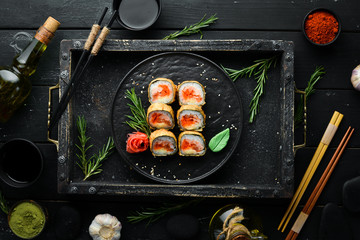 Sushi rolls with tuna and caviar. Sushi set on a black stone plate. Top view.