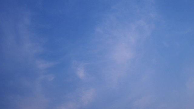 A blue sky with beautiful wisp of cloud for use as a backing or backdrop.