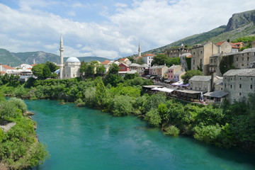 Fototapeta na wymiar Mostar Aerial panoramic view on Neretva River with old streets and mosque
