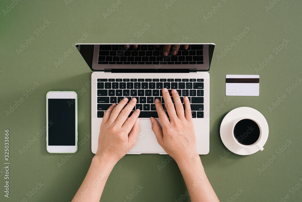 Aufkleber human using laptop top view on minimal workspace. color background and copy space.