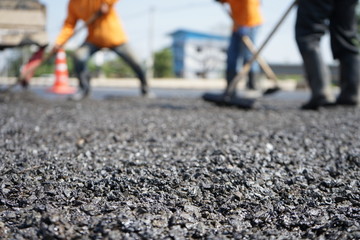 Blur image, repairing pavement mainly by manual labor