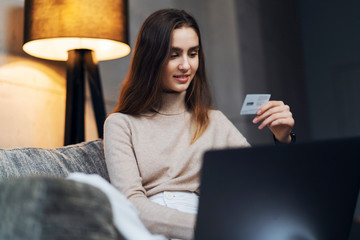 Female using a bank card to buy things online. Retail stores offering bonus cards to customers....