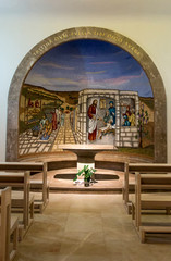 Fototapeta na wymiar Magdala, Israel, January 26, 2020: Side altar in the church in Magdala on the Galilee Lake (Tiberiacn) with a mosaic depicting Jesus resurrects Jair's daughter