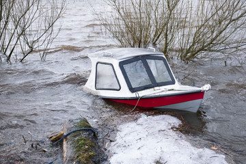 Boat capsized sunk in flooded lake due to deep river water Balmaha in Loch Lomond