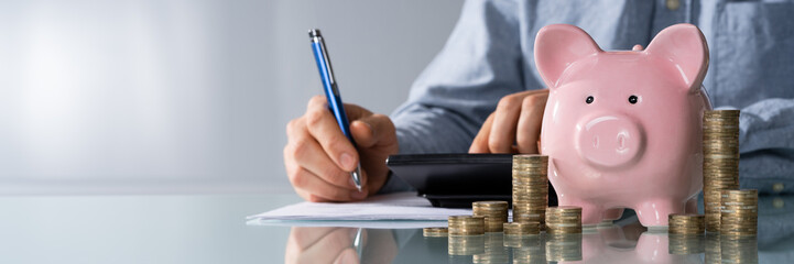 Businessman Calculating Invoice On Desk