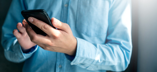 close up businessman hand hold smartphone cpmmunication ideas concept