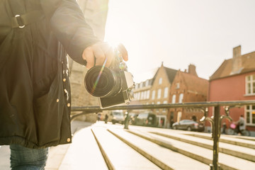 closeup asian woman hand hold retro camera traveller with background of old tradition architecture,asian photograper travel with retro camera
