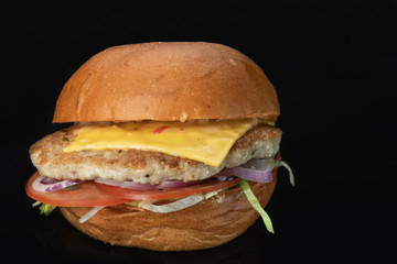 Burger on a dark background, with a mirror reflection for the menu
