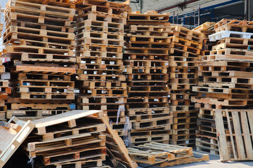 Wooden pallets stack at the freight cargo warehouse for transportation and logistics industrial, Driver forklift loading,	