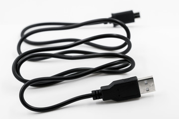 Black adapter USB to micro USB type c data and power cable on white background. Closeup