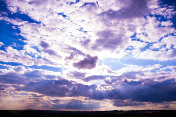 A sky with the sun, blue sky and clouds