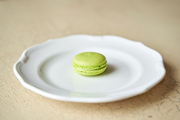 French macaroon dessert on white plate. Modern european French cuisine.