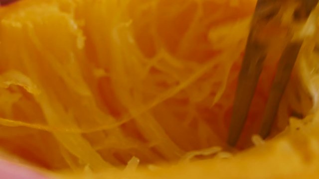 Extreme closeup on the noodle like strands of spaghetti squash. The delicious autumn vegetable is a delicious pasta alternative for gluten free cooking, paleo diets and plant based cooking.